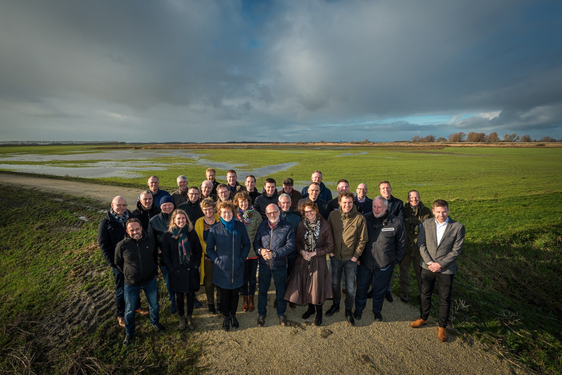 Groepsfoto delegatie Flevoland in weiland.